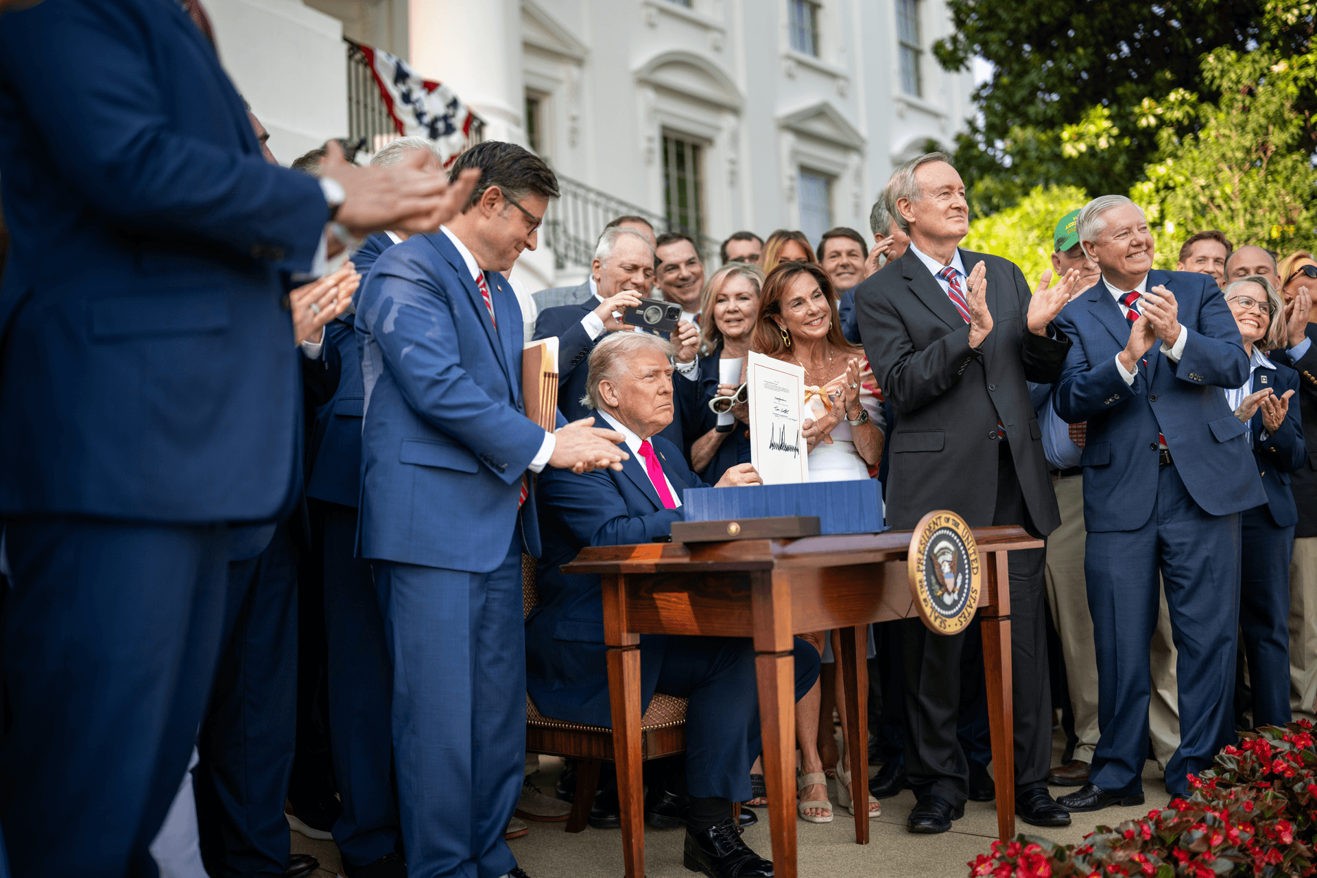 President Trump signing the One Big Beautiful Bill Act into law on the White House South Lawn on July 4, 2025